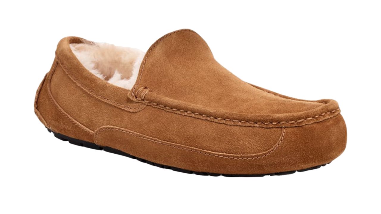 A tan moccasin slipper on a white background.