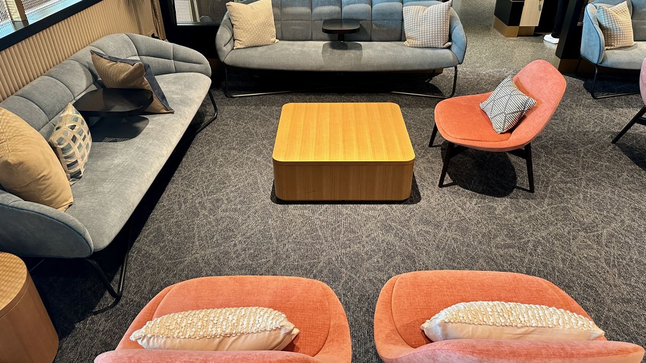A couch and lounge chairs in the Sapphire Lounge