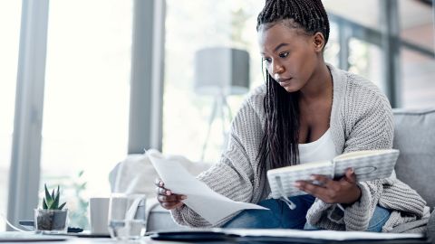 black woman with bills debt consolidation