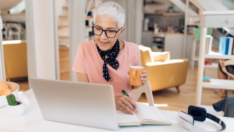 woman on laptop checking short term investments