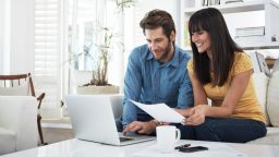 couple on laptop looking at investments and bills