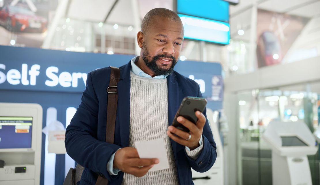 underscored man on phone airport