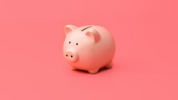 piggy bank on pink background investing build wealth
