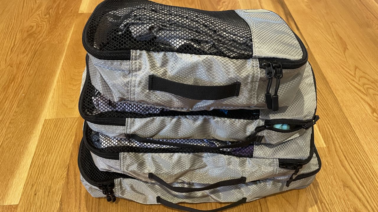 A photo of three Amazon Basics packing cubes stacked on top of each other