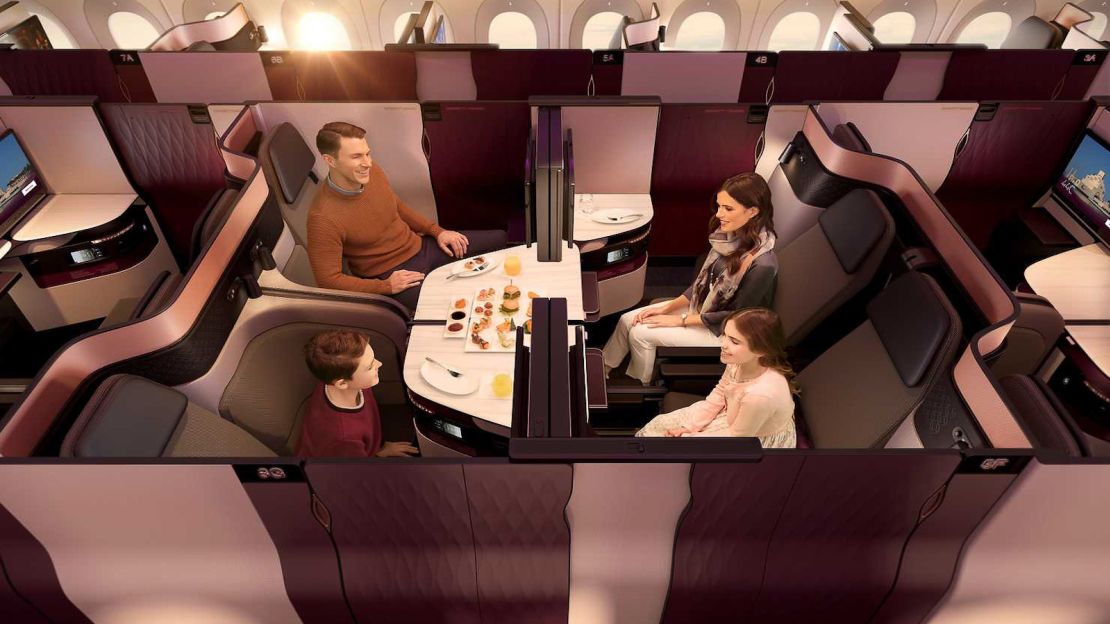 A photo of a family of four sitting in Qsuites business class