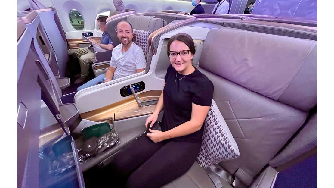 A photo of the author and her husband sitting in Singapore Airlines business class seats