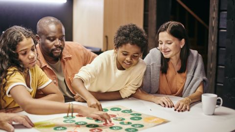 underscored travel games lead family playing board game