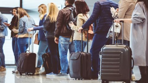 underscored travelers queue airport