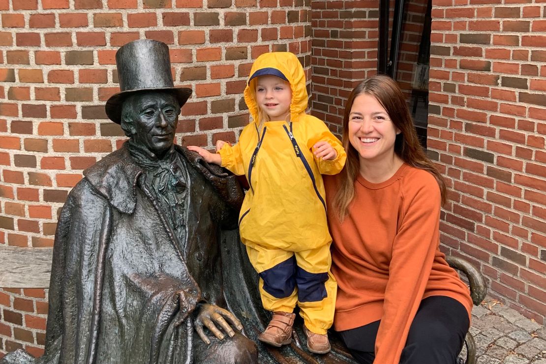 Brooke Black and her daughter pose with a statue of Danish author Hans Christian Andersen in Odense, Denmark.