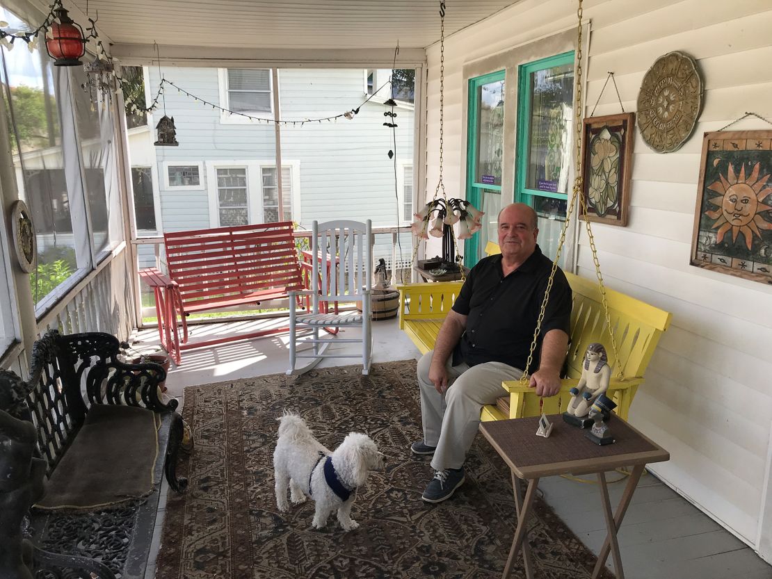 Richard Russell, a certified camp medium and healer, relaxes with his dog, Harley, at home in Cassadaga.