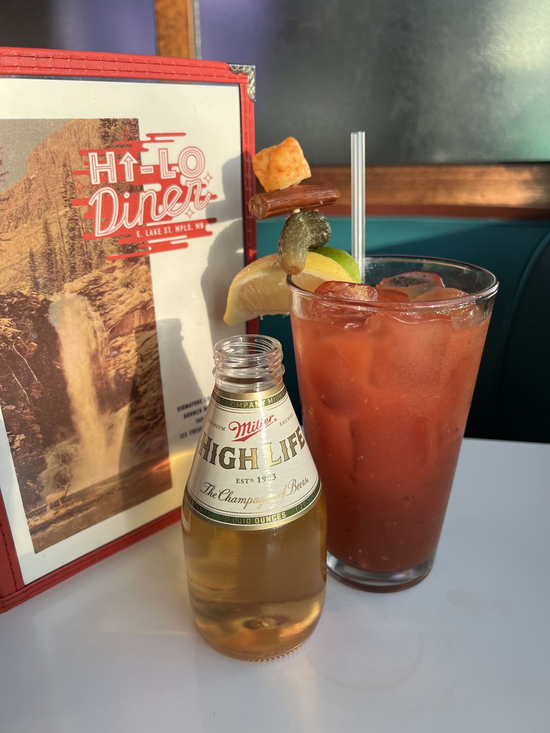 The 'Hi-Lo Bloody' at the Hi-Lo Diner in Minneapolis, Minnesota. The drink includes some unique African spices, a house-made vegan Worcestershire sauce and is skewered with a very non-vegan buffalo cheese curd and Slim Jim bit.
