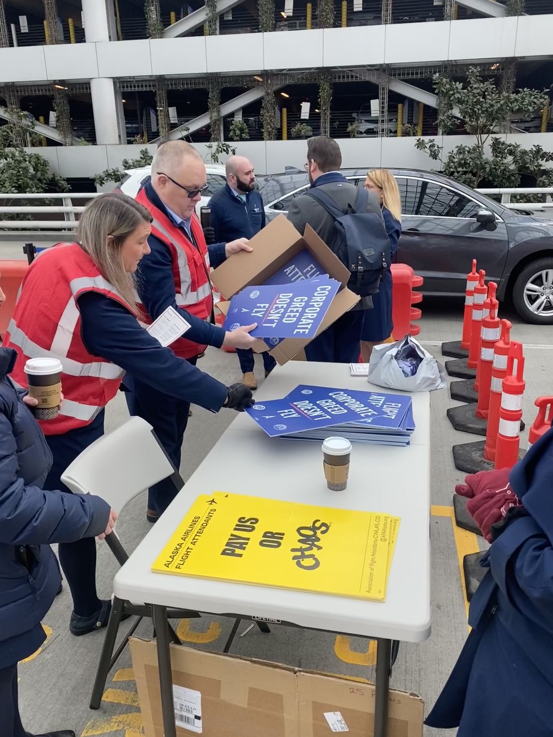 Steve Maller prepares picket signs today at the Portland, Oregon, airport.