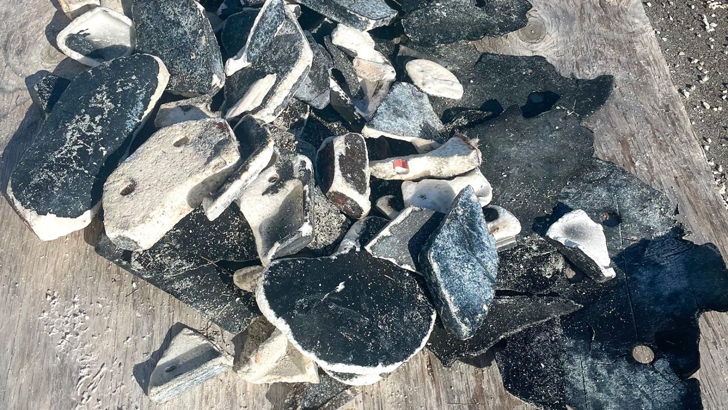 there is a pile of broken skateboards on the ground