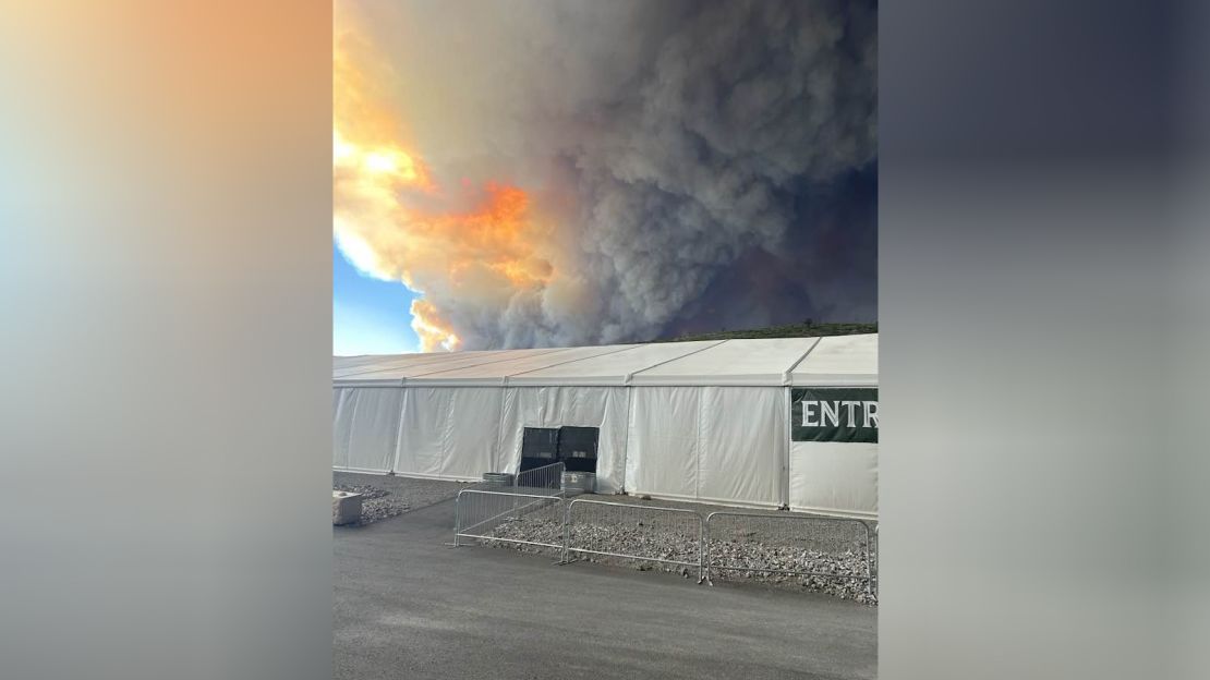 A wall of smoke looms of Ruidoso as its residents evacuate on June 17.