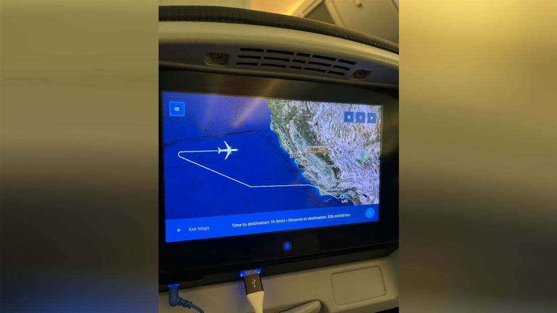 An inflight screen on United Airlines Flight 198, shot by Yang Shuhan, shows the plane diverting to SFO.