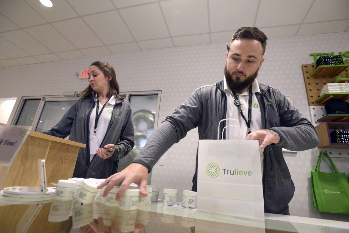 Leah Hartigan and Brandon Garcia ring up an order for a customer at the Trulieve Fort Walton Beach Dispensary in Florida in August 2020.