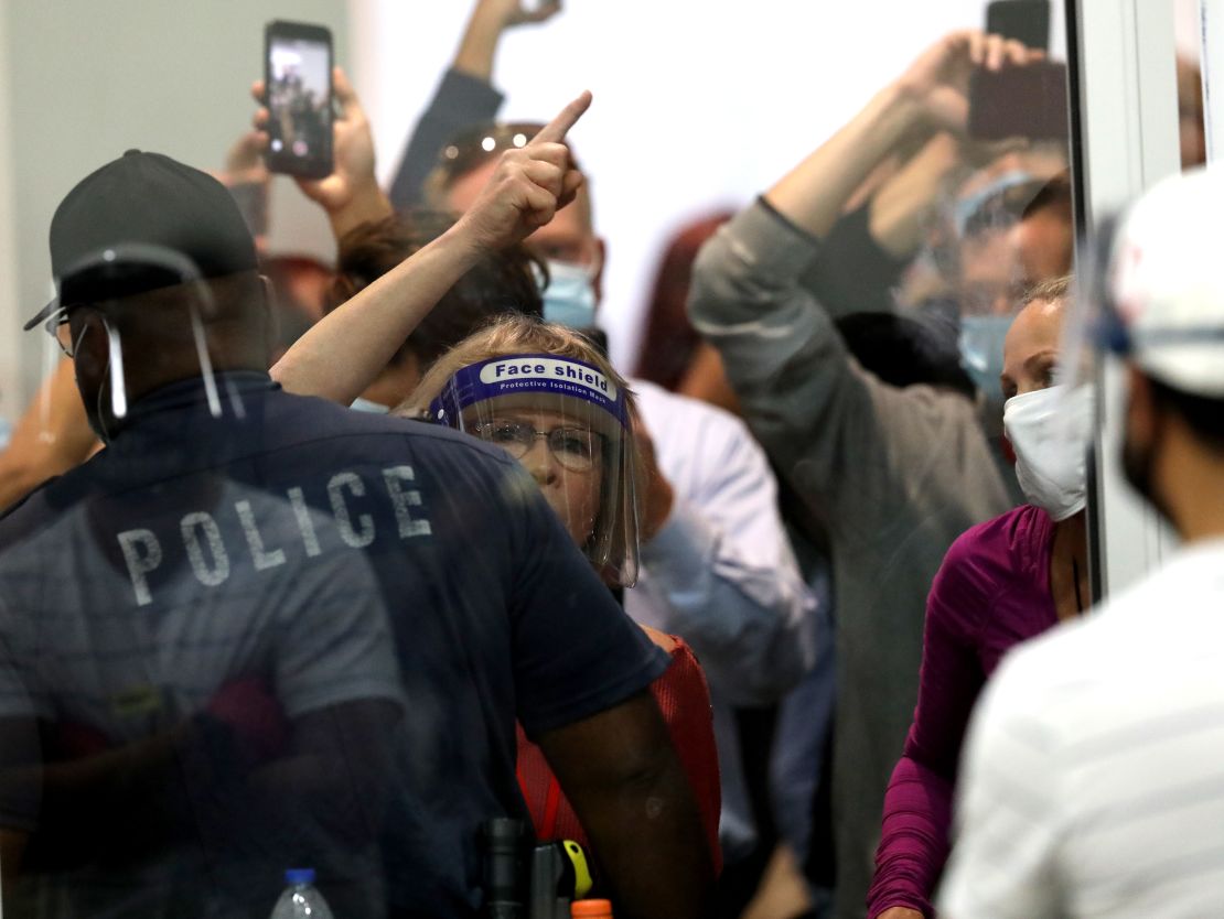 In this November 2020 photo, people challenging the 2020 election stand outside the TCF Center where the ballot count continued in Detroit.