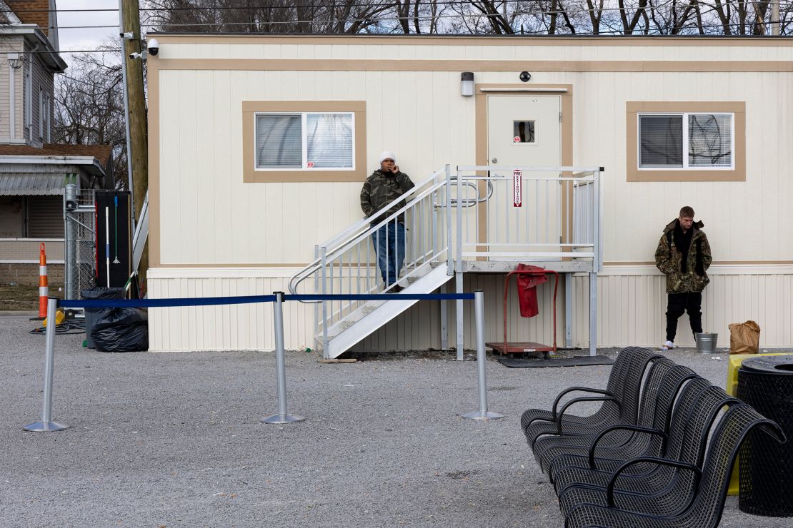 People wait outside a makeshift Greyhound bus stop in a trailer in Arlington Heights, Cincinnati, in 2023. The downtown terminal closed.