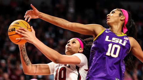South Carolina Gamecocks center Kamilla Cardoso, left in white jersey, drives past LSU Lady Tigers forward Angel Reese, right in purple jersey