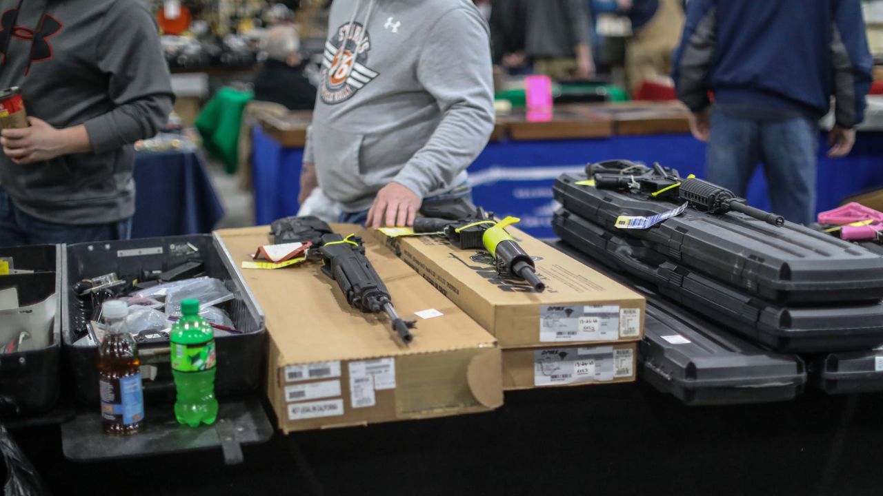 People browse guns for sale, during the Novi Gun and Knife Show at Suburban Collection Showplace in Novi, Mich. on Feb. 24, 2018.