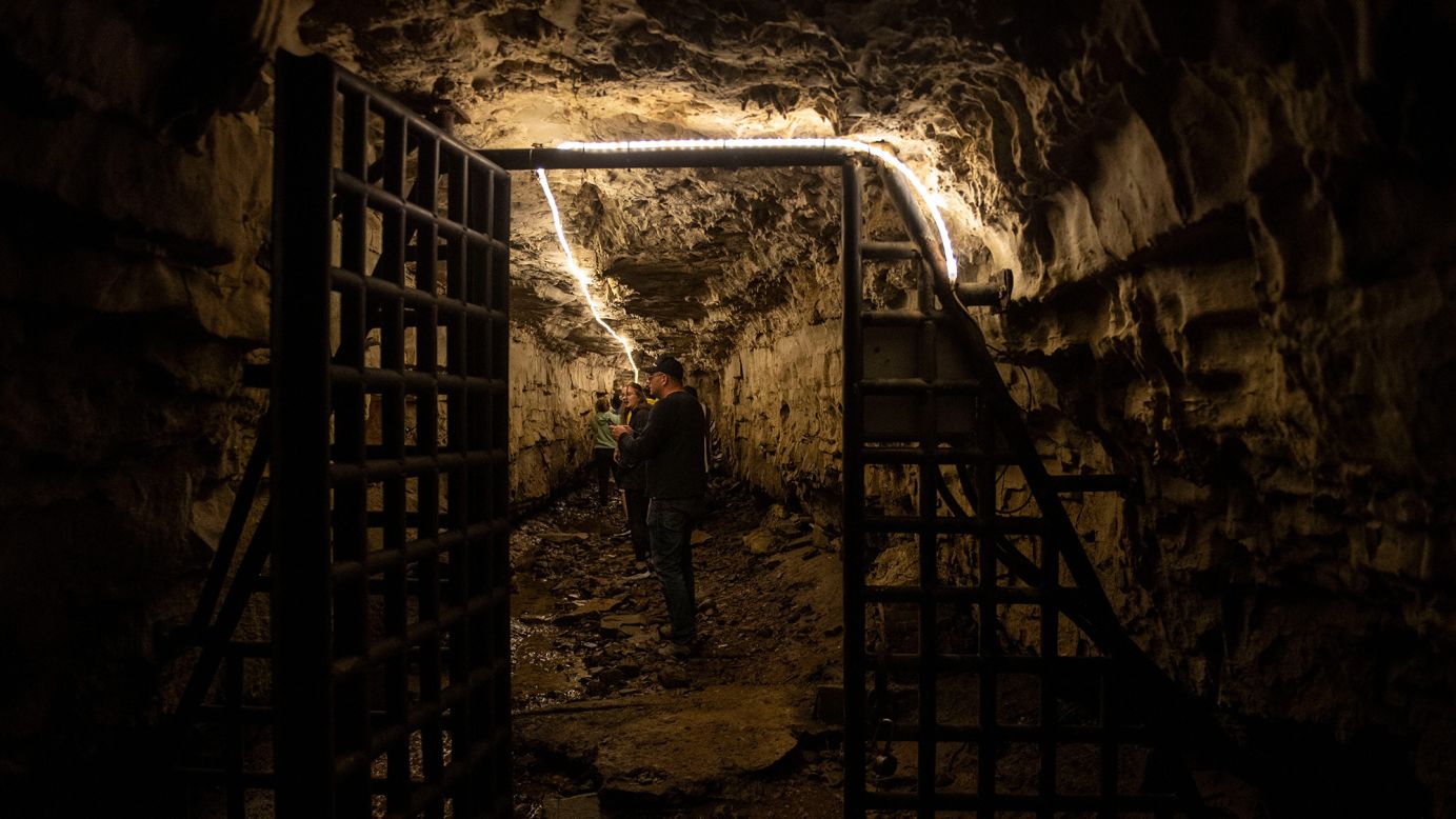 A visitor explores Bell Witch Cave in Adams, Tennessee. The cave is the purported onetime home of an evil witch.