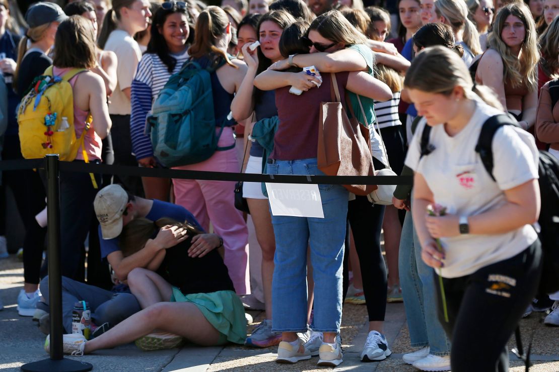 Students mourn the loss of two fellow students at the University of Georgia's Tate Plaza on Monday, February 26, 2024.