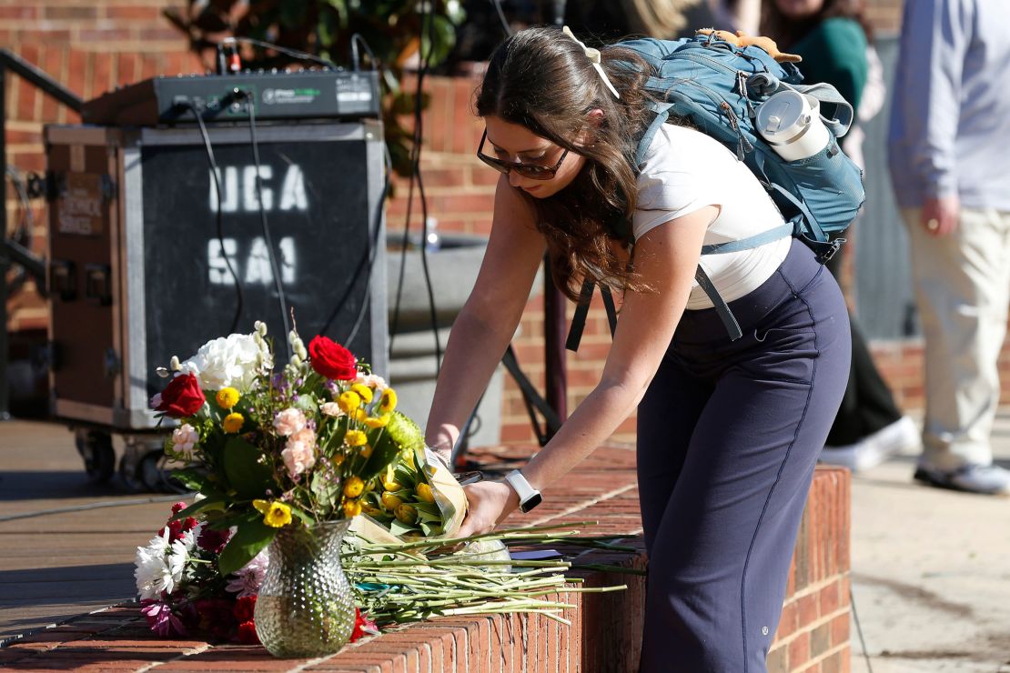 UGA students leave flowers after a vigil for Laken Riley and a UGA freshman who died on campus.