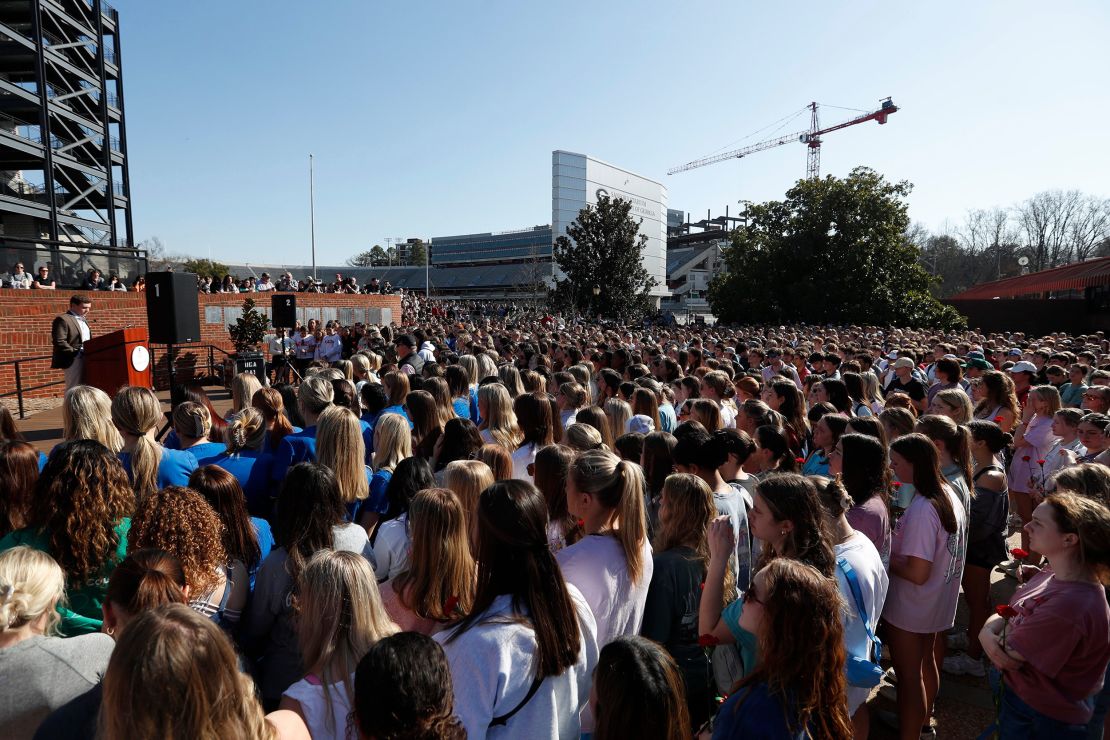 A large crowd listens during a vigil for two students.