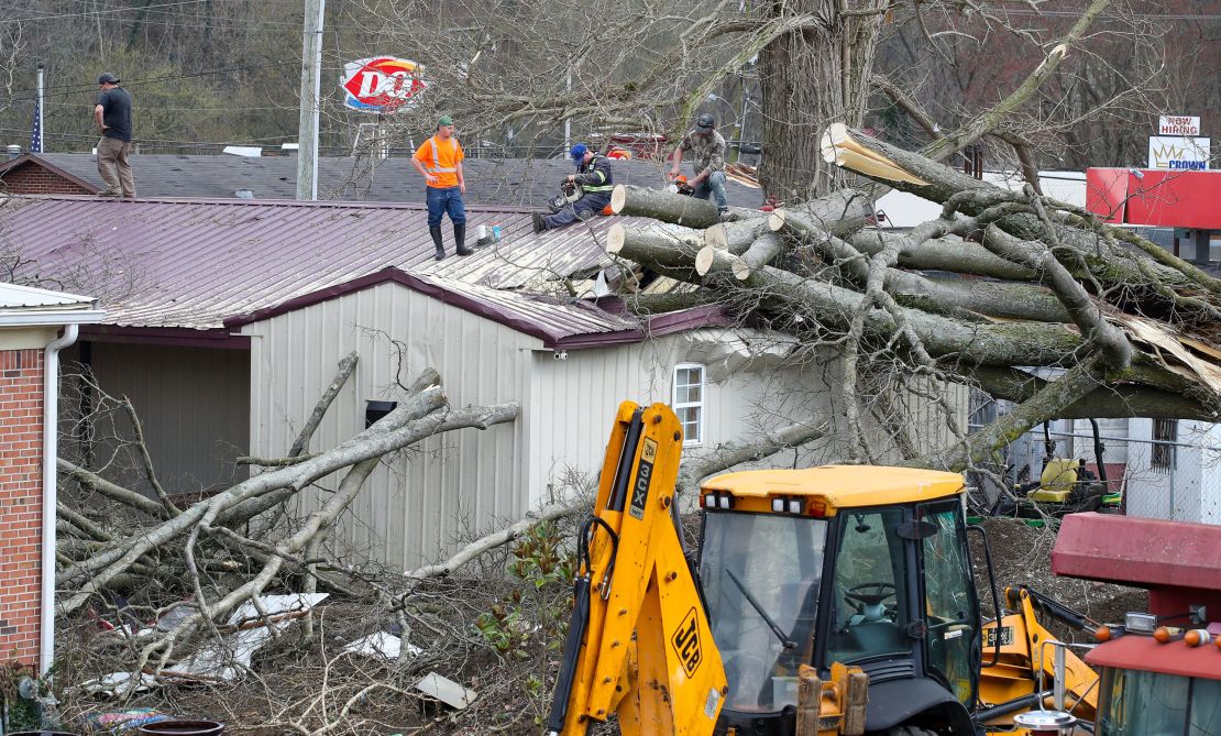 Crews work to clean up after a reported tornado touched down Thursday in Milton, Kentucky.