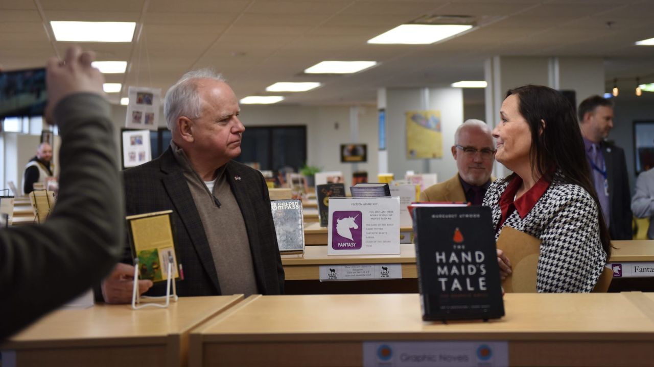 Minnesota Democratic Gov. Tim Walz speaks to a library specialist at Como Senior High School in St. Paul, Minn. about his proposal to prohibit book banning. on March 21, 2024.