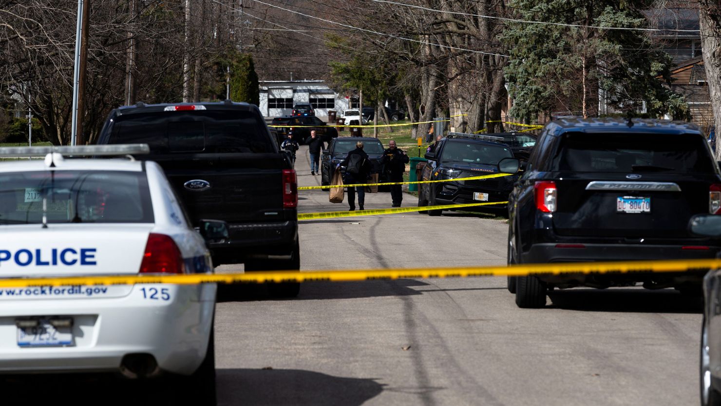 Law enforcement officers work a crime scene on Wednesday, March 27, in Rockford, Illinois.