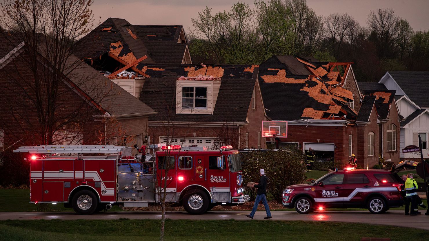 Emergency personnel respond to storm damage in Buckner, Kentucky, after several houses were damaged when severe storms hit the area on Tuesday.