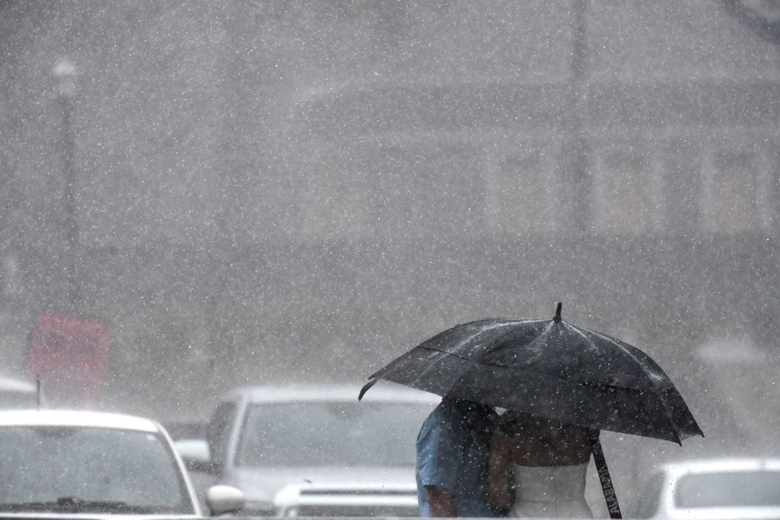 Heavy rain pours down on fans outside Bryant-Denny Stadium in Tuscaloosa, Alabama, in August 2024.