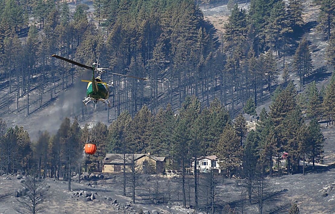 A helicopter transports water in order to fight the Davis Fire in the Washoe Valley, south of Reno.