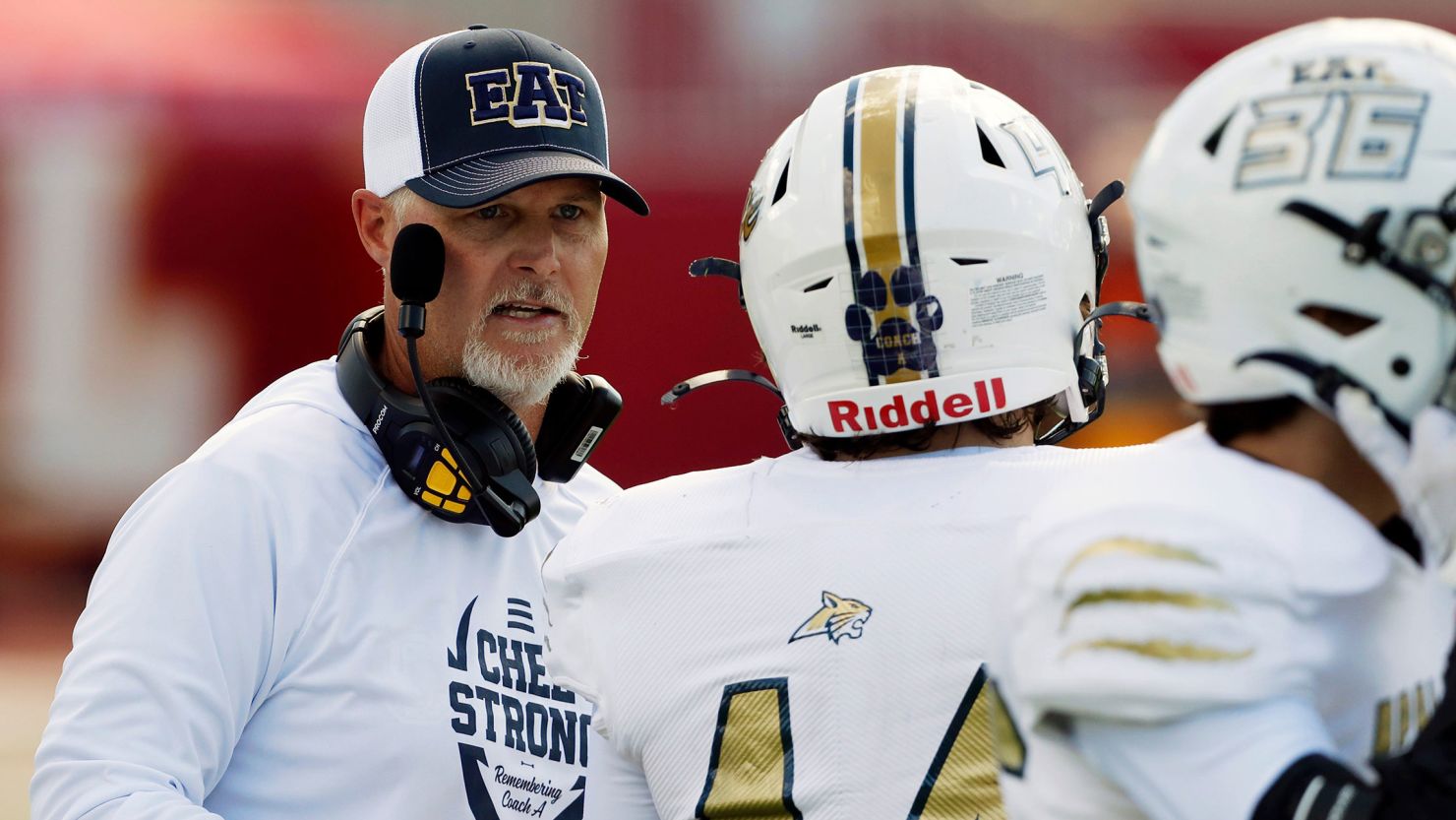 Apalachee Coach Mike Hancock speaks with a player during a game in Athens, Georgia, in September 2024.