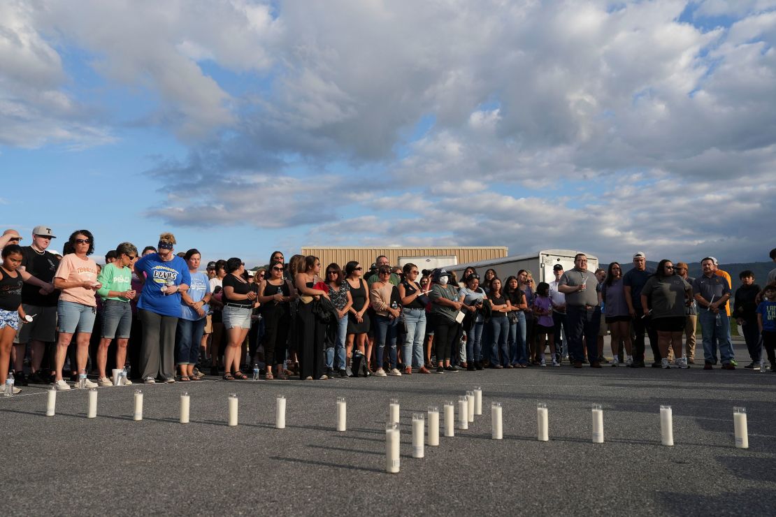 Candles are set out in the shape of a cross where almost 200 people gathered for a candlelight vigil on Thursday for the Erwin, Tennessee, flood victims.