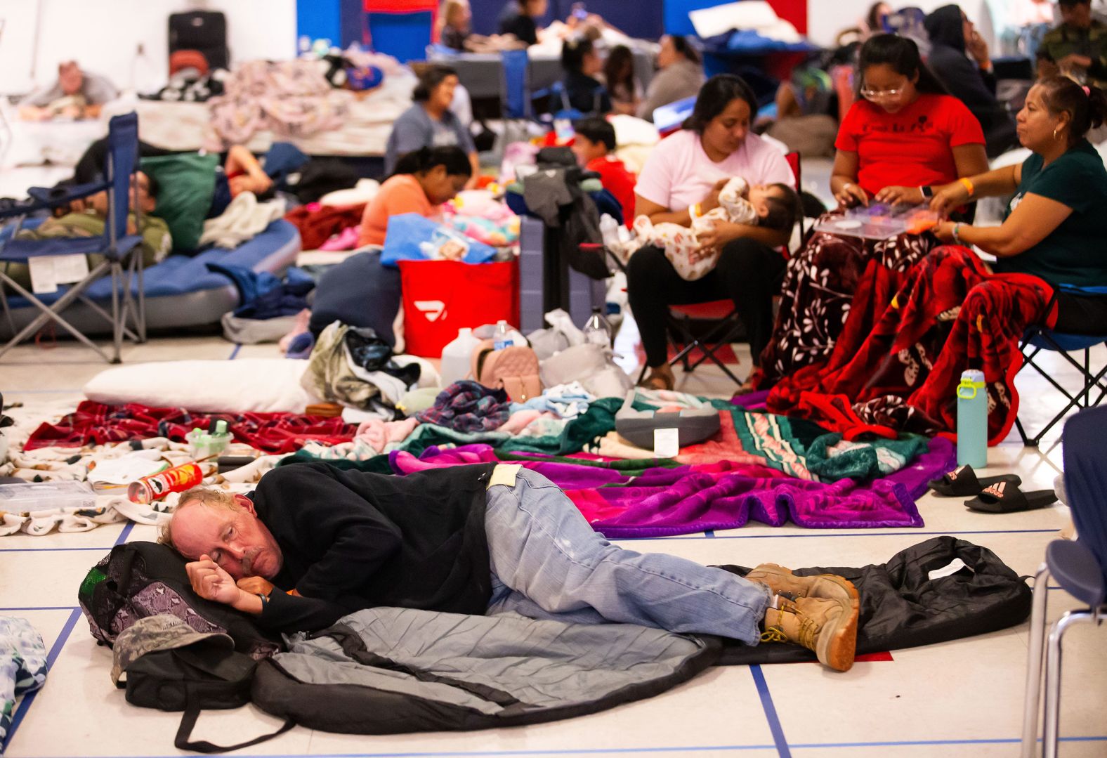 Stephen Lundgren lies on the floor of the Vanguard High School cafeteria as he tries to get some sleep at the Ocala, Florida, shelter on Wednesday.