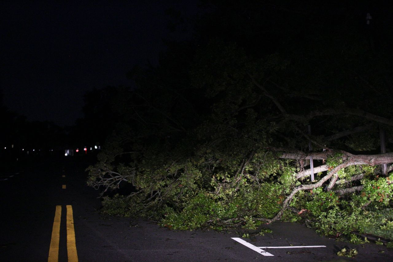 Crews work to remove debris from downed trees blocking roads in downtown Vero Beach, on Wednesday.