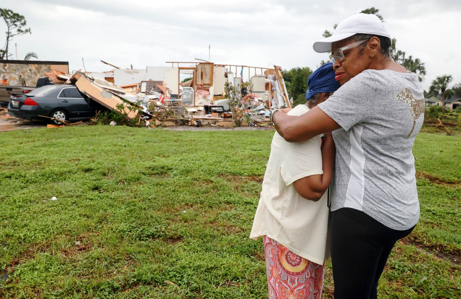 Connie Gore, left, is comforted by her friend and neighbor Cecelia Smith on Friday, October 11, after a tornado caused by Hurricane Milton devastated her home in Martin County, Florida.