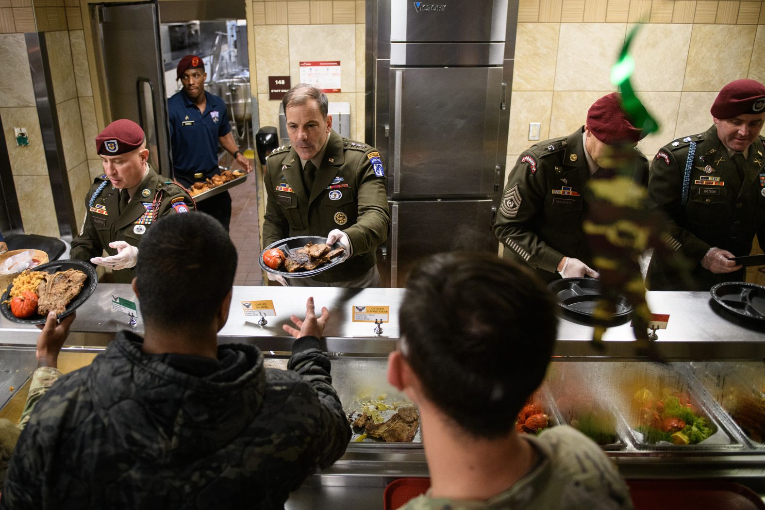 US Army Lt. Gen. Christopher Donahue helps serve early Thanksgiving meals to paratroopers and families at North Carolina’s Fort Liberty on Tuesday, November 26.