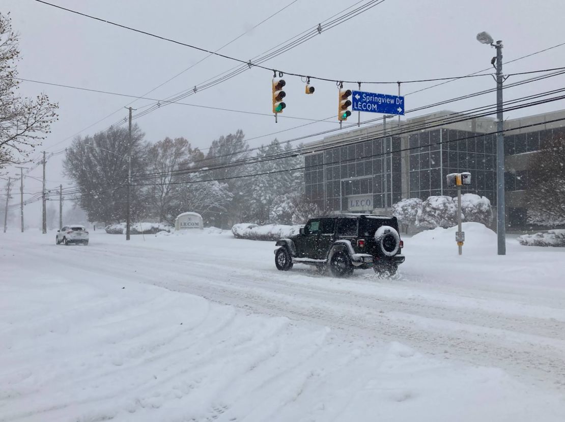 Drivers move slowly on a snow-covered Grandview Boulevard in Erie, Pennsylvania, on Friday, November 29.