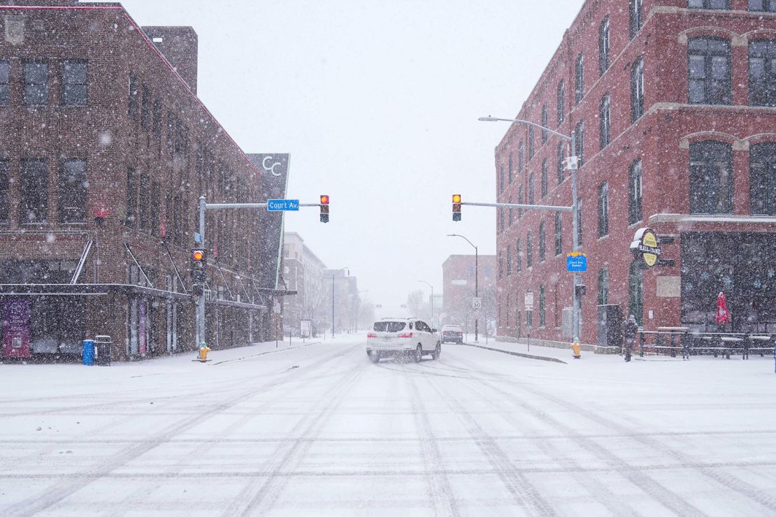 A car slides around a corner amid snow in Des Moines, Iowa, on Thursday. Scenes like this will be playing out across the eastern two-thirds of the US once a major winter storm hits over the weekend.