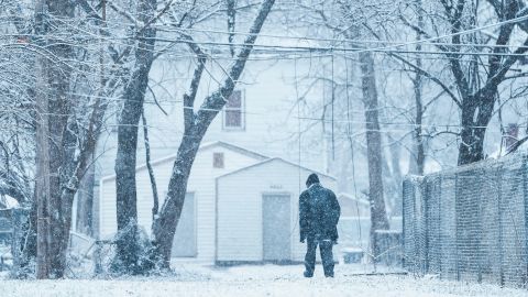 A man walks through the snow in a Louisville, Kentucky, neighborhood on Tuesday.