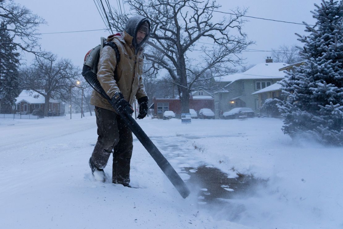 Josh Mortensen clears snow in Des Moines, Iowa, Wednesday.