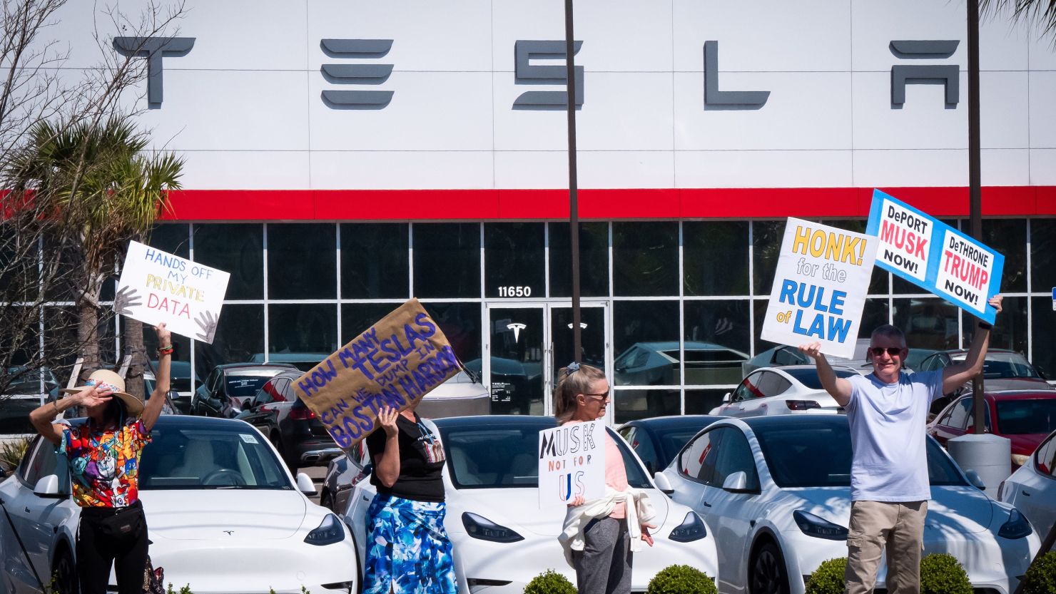 ‘Tesla Takedown’ protesters gather outside showrooms to rally against