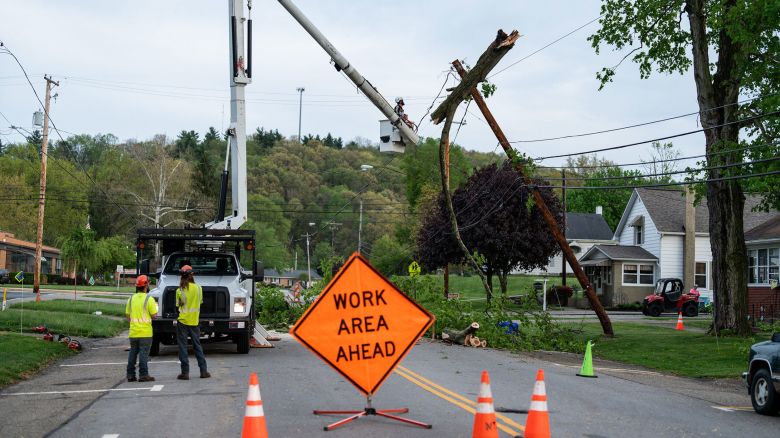 A crew works to remove a tree from a power pole in in Gnadenhutten, Ohio, after severe thunderstorms Tuesday.