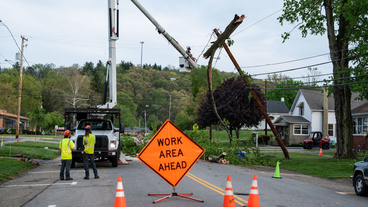A crew works to remove a tree from a power pole in in Gnadenhutten, Ohio, after severe thunderstorms Tuesday.