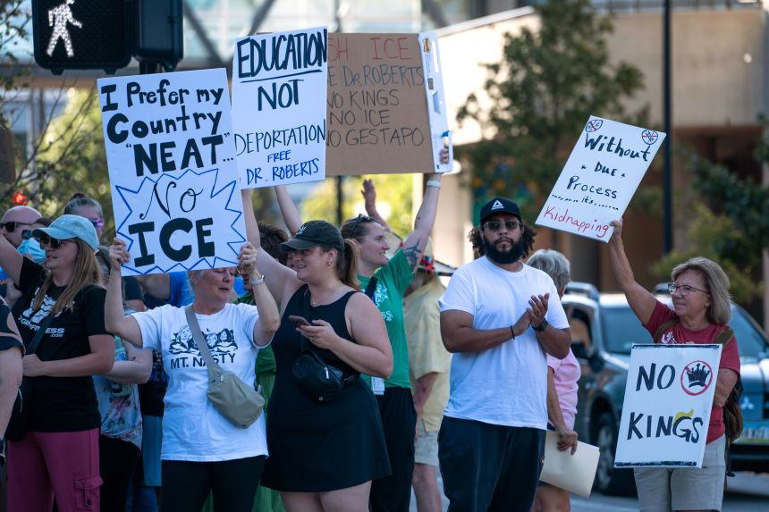 Community members gather to condemn Roberts' arrest during a protest at the Federal Building on Friday,.