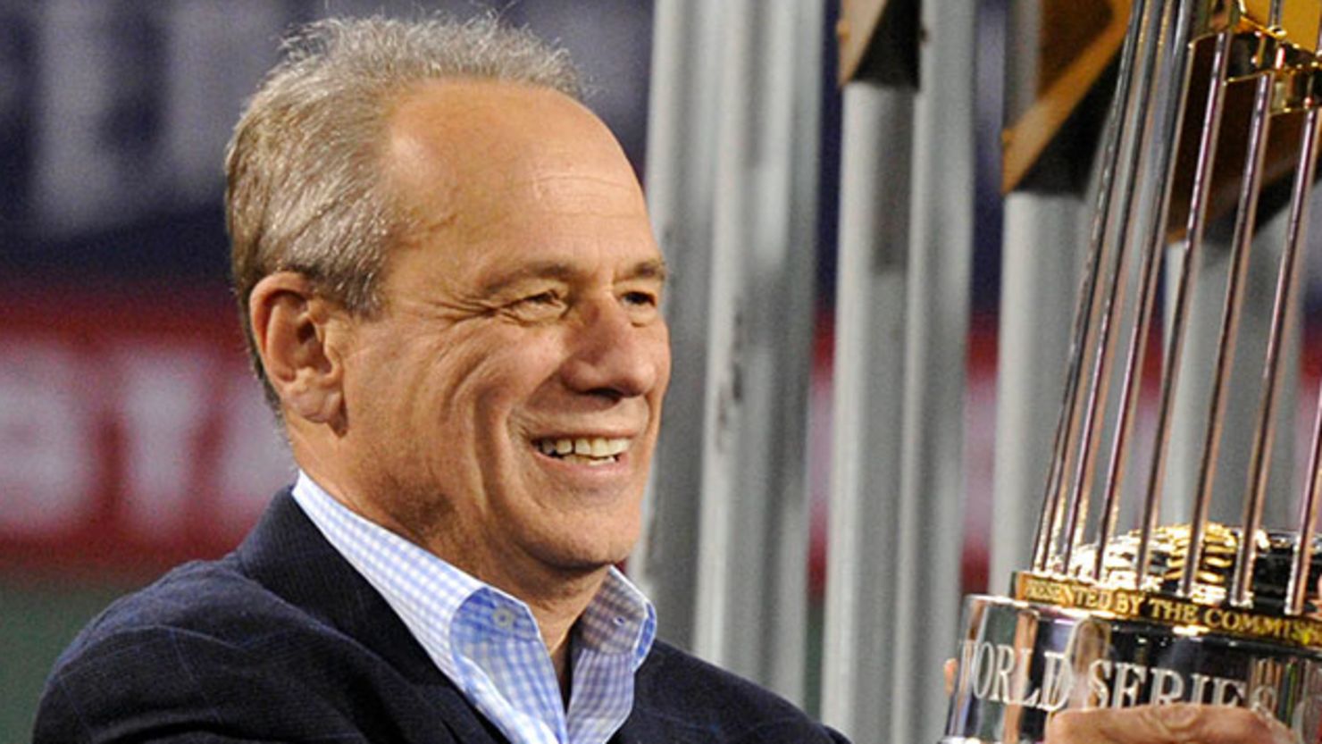 Larry Lucchino seen hold the World Series championship trophy together after game six of the MLB baseball World Series.