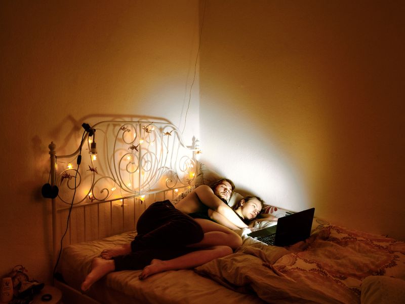 Many of the images show young people with their faces illuminated by the glow of a mobile or laptop screen.